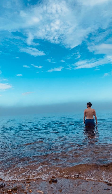 three photos of a person emerging into the ocean's calm blue water