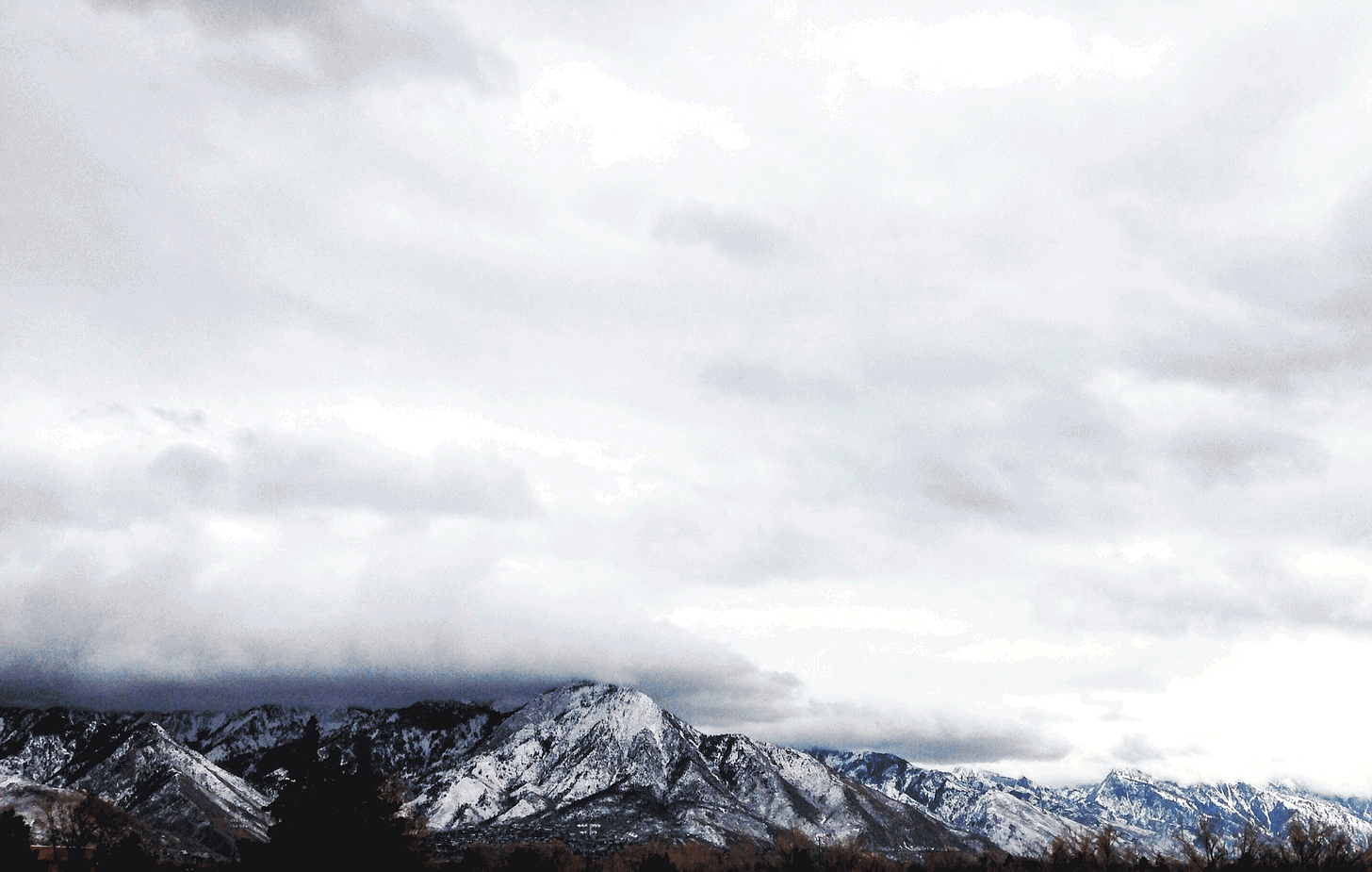 GIF of a series of photos of Mount Olympus, from mostly the same view. Sky colors range from black and white to bright pinks and purples and blues.