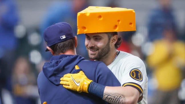 Garrett Mitchell wearing a cheesehead hat