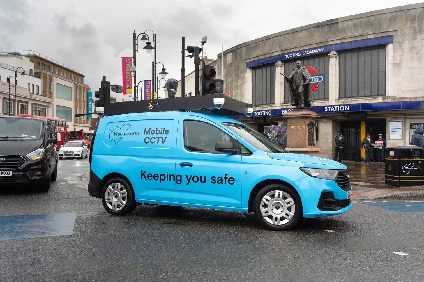 May be an image of 4 people, car, van and text that says "TOOTING BROADWAY UND 6Hи TOOTING BBO Wandsworth Mobile W CCTV NXO STATION ETENDNE F0.0 Keeping you safe Wandawart" May be an image of 4 people, car, van and text that says "TOOTING BROADWAY UND 6Hи TOOTING BBO Wandsworth Mobile W CCTV NXO STATION ETENDNE F0.0 Keeping you safe Wandawart"