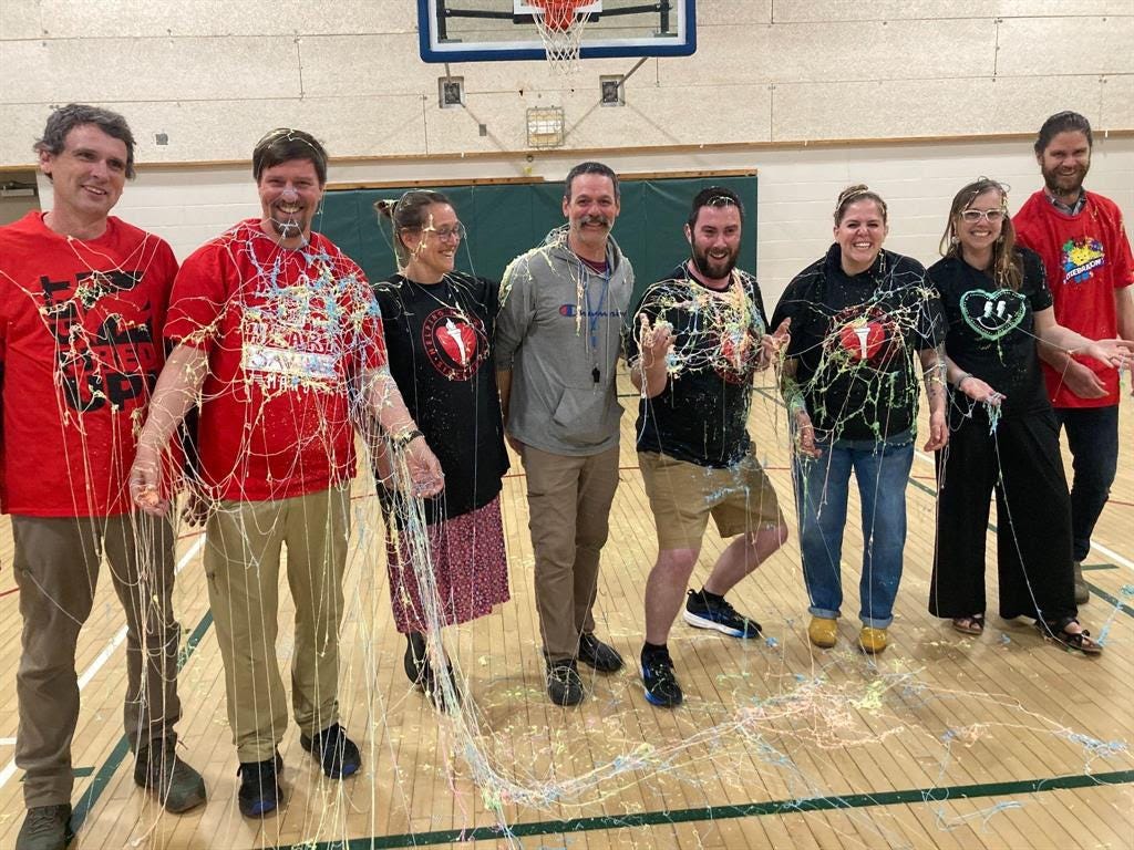 Staff members covered in silly string