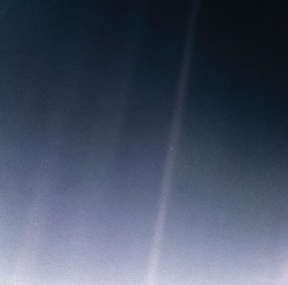Pale blue dot picture: a photograph of Earth taken in 1990, by the Voyager 1 space probe from a distance of over 6 billion kilometers. In the photograph, Earth's apparent size is less than a pixel; the planet appears as a tiny dot against the vastness of space, among bands of sunlight reflected by the camera. 