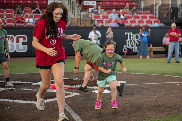 TROY student-athletes help celebrate opening night of the Miracle League with Miracle League players on Monday night at Riddle-Pace field. The Troy Miracle League in Troy, Alabama, provides children and adults of all ages with disabilities the opportunity to play baseball, and have fun. (Photos/Joey Meredith)