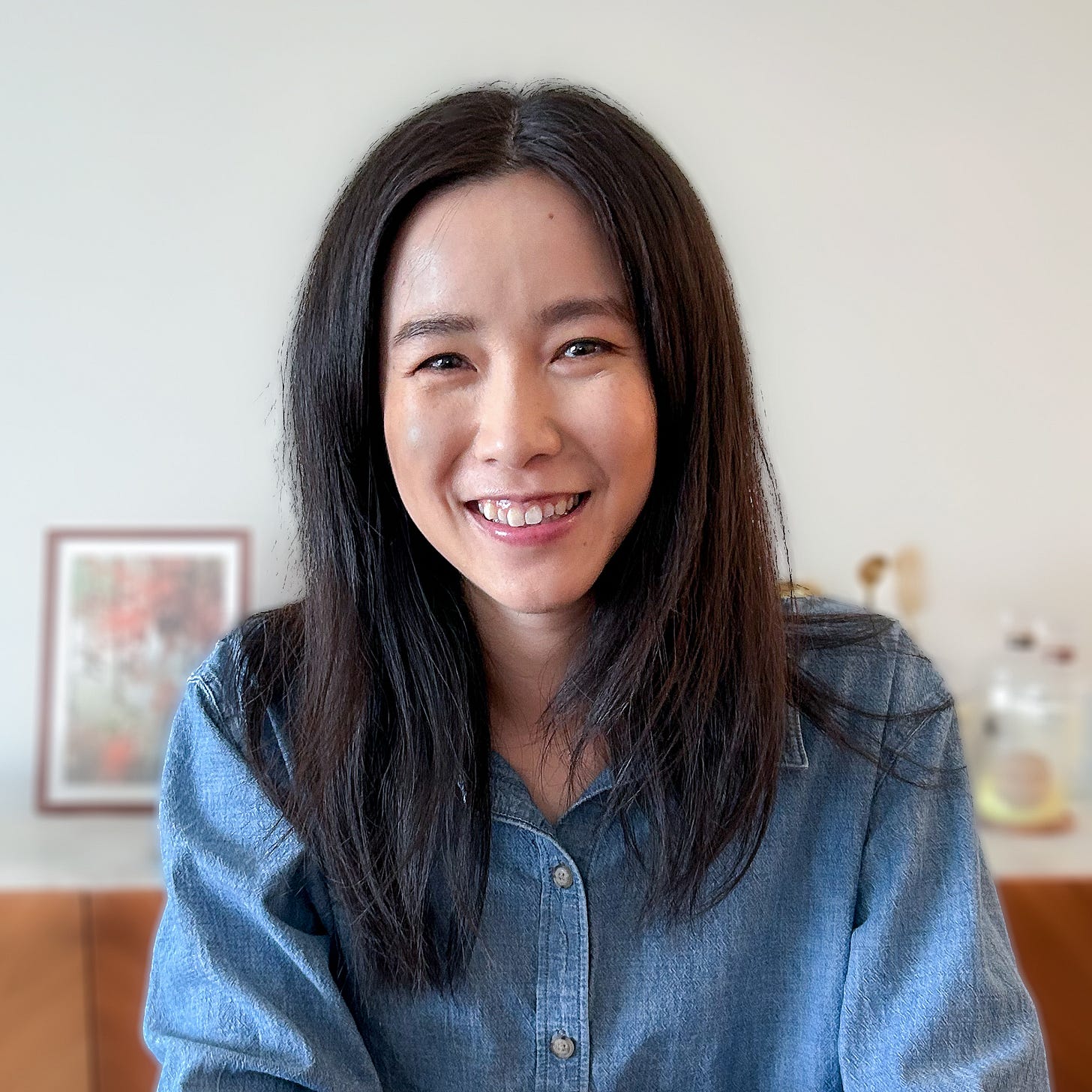 Woman with medium length black hair smiling to the camera