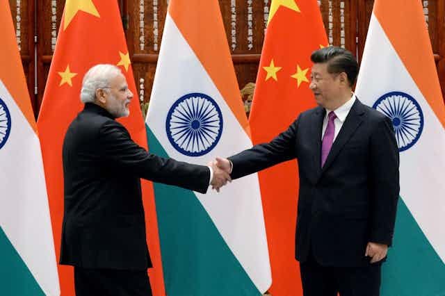 Modi and Xi shake hands Modi and Xi shake hands