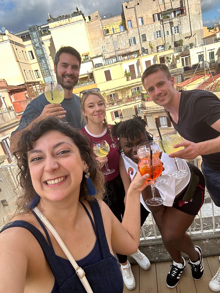 sharing some cold cuts, magherita pizza, an empty cup of tiramisu, pasta and a group shot on the rooftop