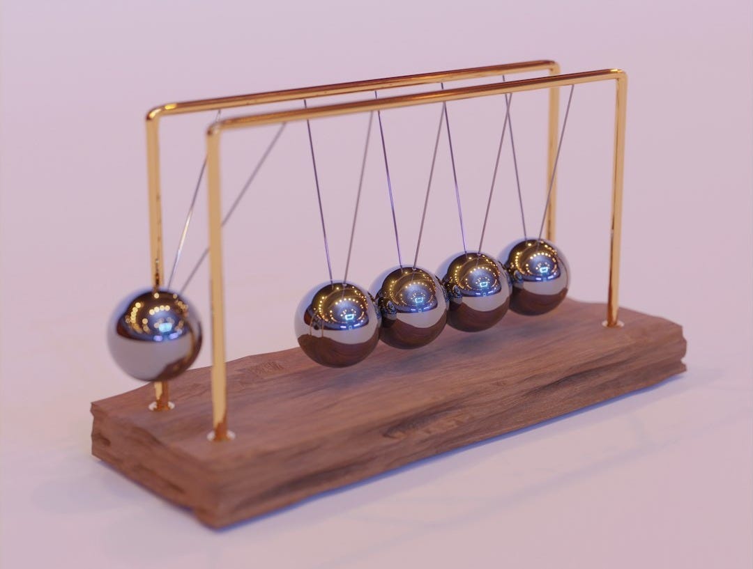 a wooden stand with three metal balls on it