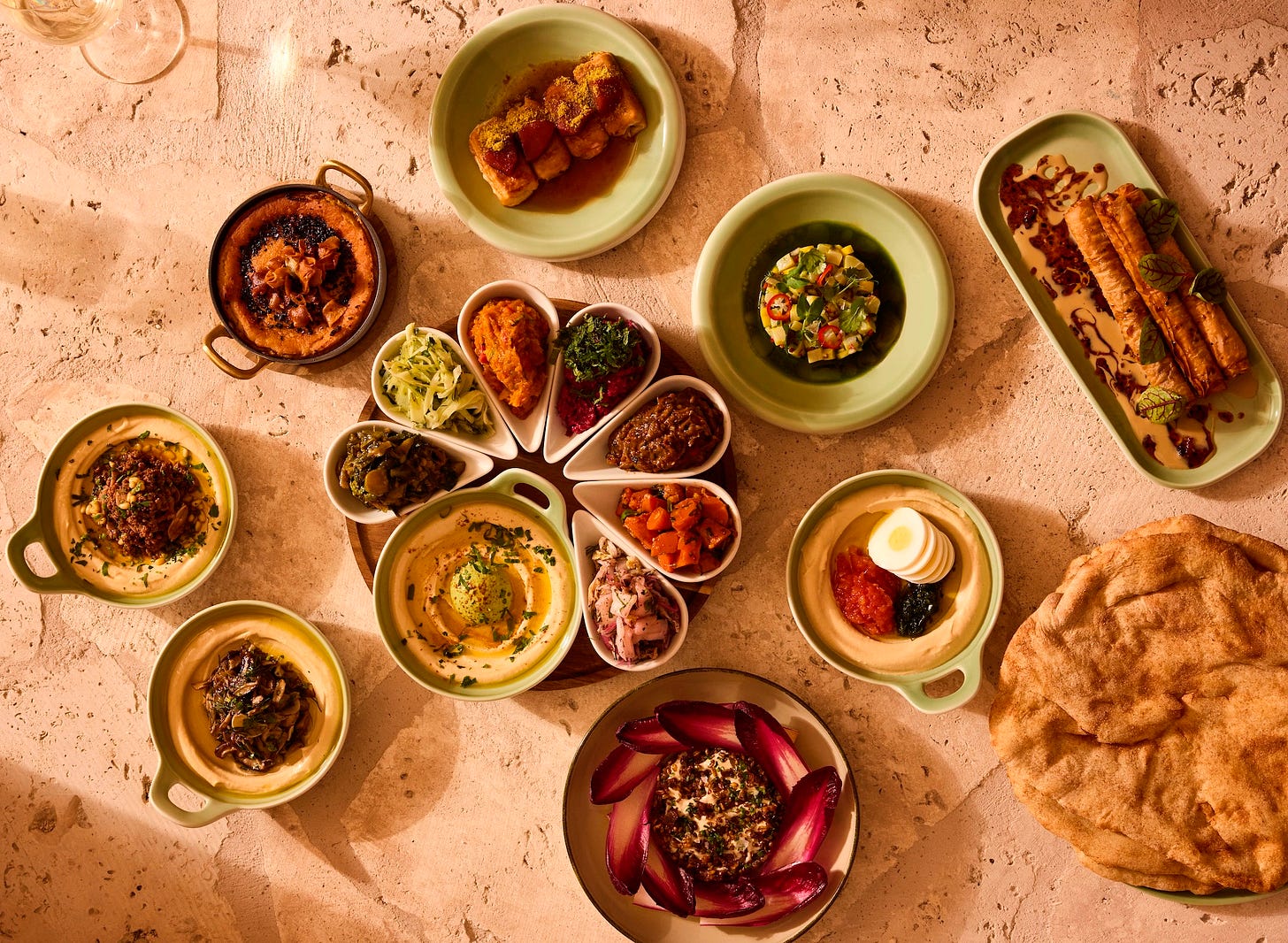 hummus and other dishes on earthen plates