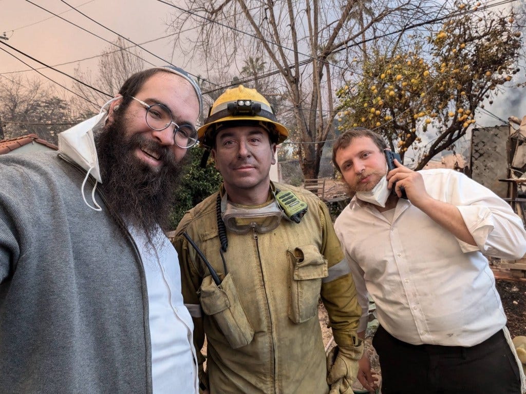 Rabbi Zushi Rivkin, Rabbi Laibel Hanoka, and a local firefighter standing together in Pasadena, coordinating fire response efforts