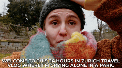 Hannah crying and saying, "Welcome to this 24 hours in Zurich travel vlog where I'm crying alone in a park"