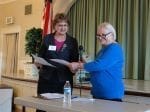 Susan's first action as President is to delegate the reading of a proposed resolution to Ruth!
