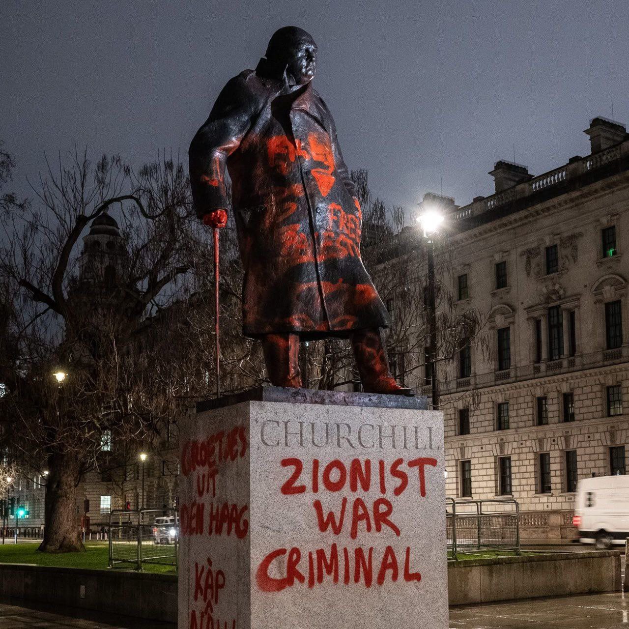 “ZIONIST WAR CRIMINAL” — Churchill’s Parliament Square statue, defaced in February 2026. The graffiti appeared more than a century after Churchill entered the political and financial circles surrounding Nathaniel Rothschild — a relationship that preceded the next Rothschild generation and the Balfour era.