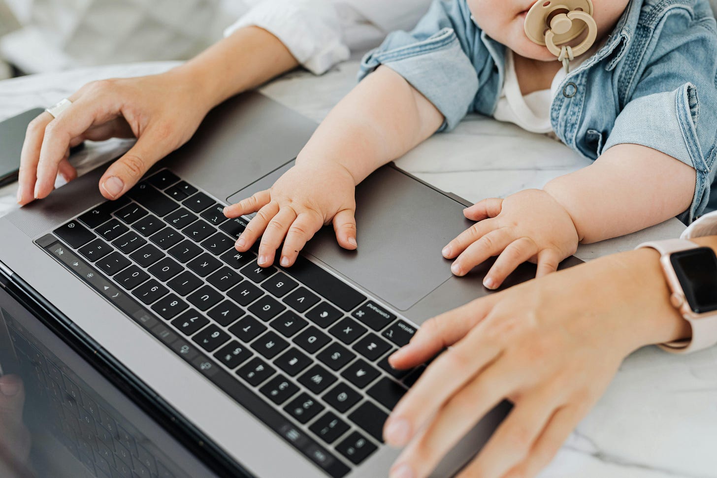 A mother and baby hands on a laptop A mother and baby hands on a laptop