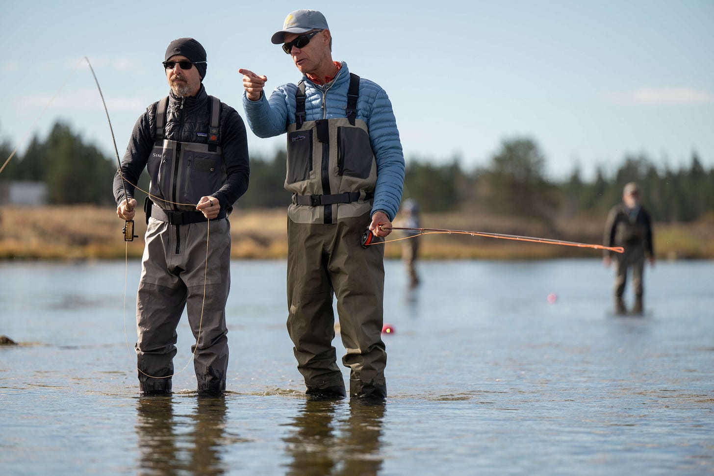 John Juracek teaching a student to cast in Idaho.