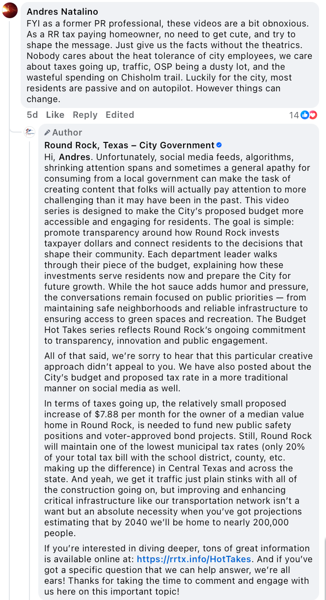 Screenshot of a Facebook comment thread. A user named Andres Natalino criticizes a city video series as “obnoxious” and suggests it should just present facts without theatrics. The official Round Rock, Texas – City Government account replies with a long, respectful response. The city explains the strategy behind the videos, emphasizing the need for engagement, transparency, and accessibility. The reply outlines budget details, addresses concerns about taxes and traffic, and provides a link for further information. The tone is professional, informative, and empathetic.
