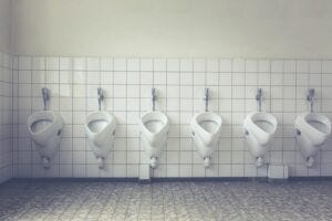 A line of urinals in a men's bathroom