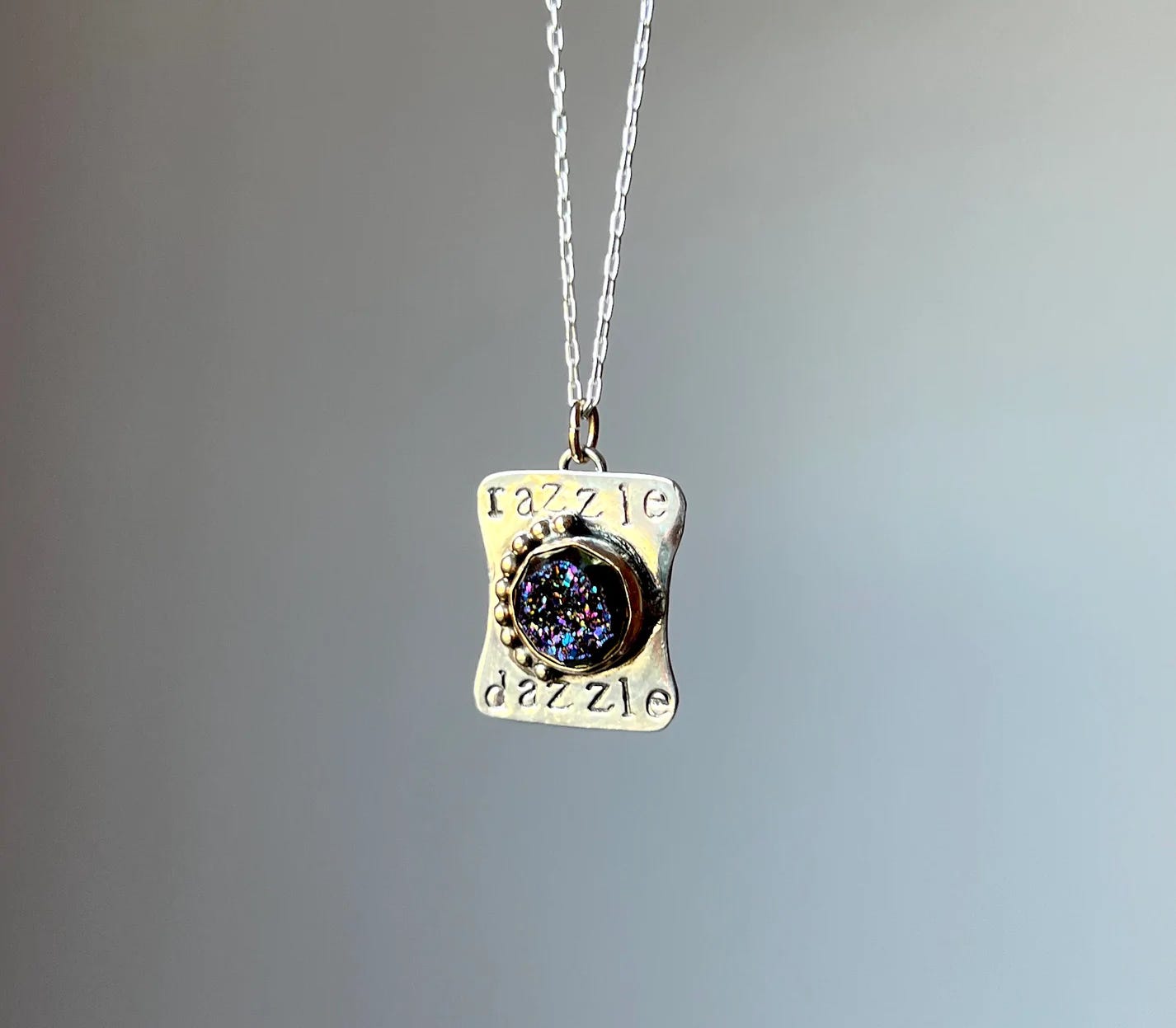 A sparkling necklace that says "razzle dazzle" by Rachel Pfeffer