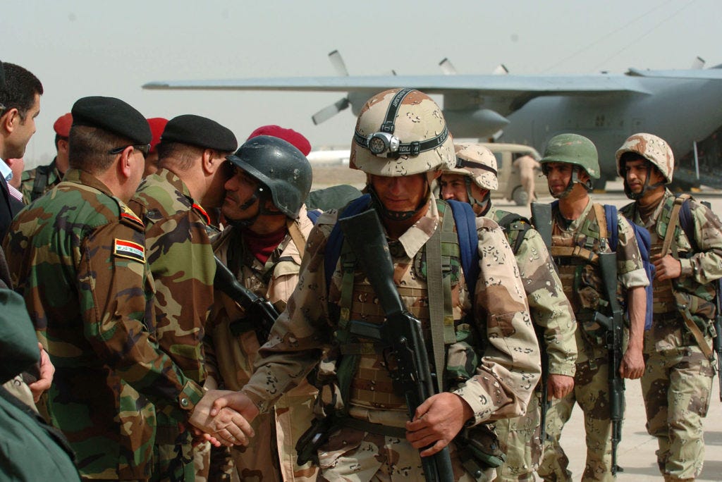 Traditional Iraqi cheek kisses and handshakes greeted the soldiers assigned to the 2nd Iraqi Army Division as they stepped onto the Baghdad International Airport tarmac, Feb. 26, 2007. The commanders of the Iraqi Ground Forces Command met every individual and spoke to them about duty, honor and their country's need for them now. U.S. Army photo by Spc. Abel Trevino -
Traditional Iraqi cheek kisses and handshakes greeted the soldiers assigned to the 2nd Iraqi Army Division as they stepped onto the Baghdad International Airport tarmac, Feb. 26, 2007. The commanders of the Iraqi Ground Forces Command met every individual and spoke to them about duty, honor and their country's need for them now. U.S. Army photo by Spc. Abel Trevino -