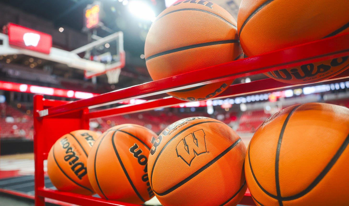 Wisconsin Badgers basketballs arranged on a rack inside the Kohl Center