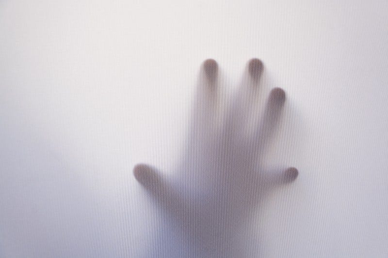 Hand touching tainted glass