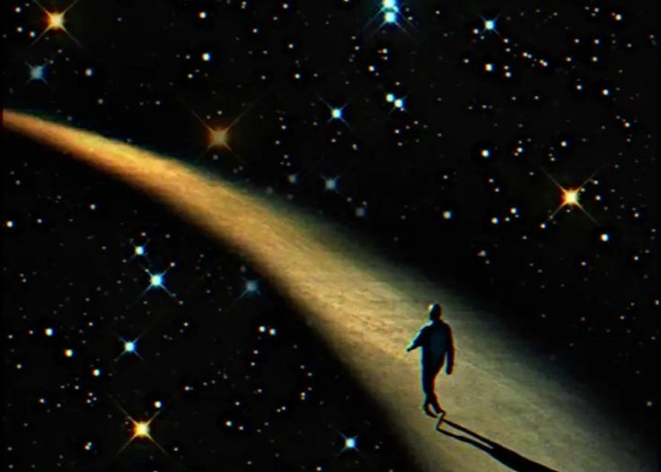 This may contain: a man walking down a path in the night sky with stars all around his body
