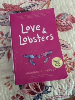 Book LOVE & LOBSTERS by Shannon M. Parker on a floral background