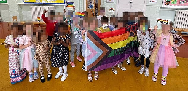 The picture which showed 20 young children, some of whom were holding up a large Progress Pride flag