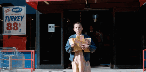 Eleven holding Eggo waffles from Stranger Things GIF