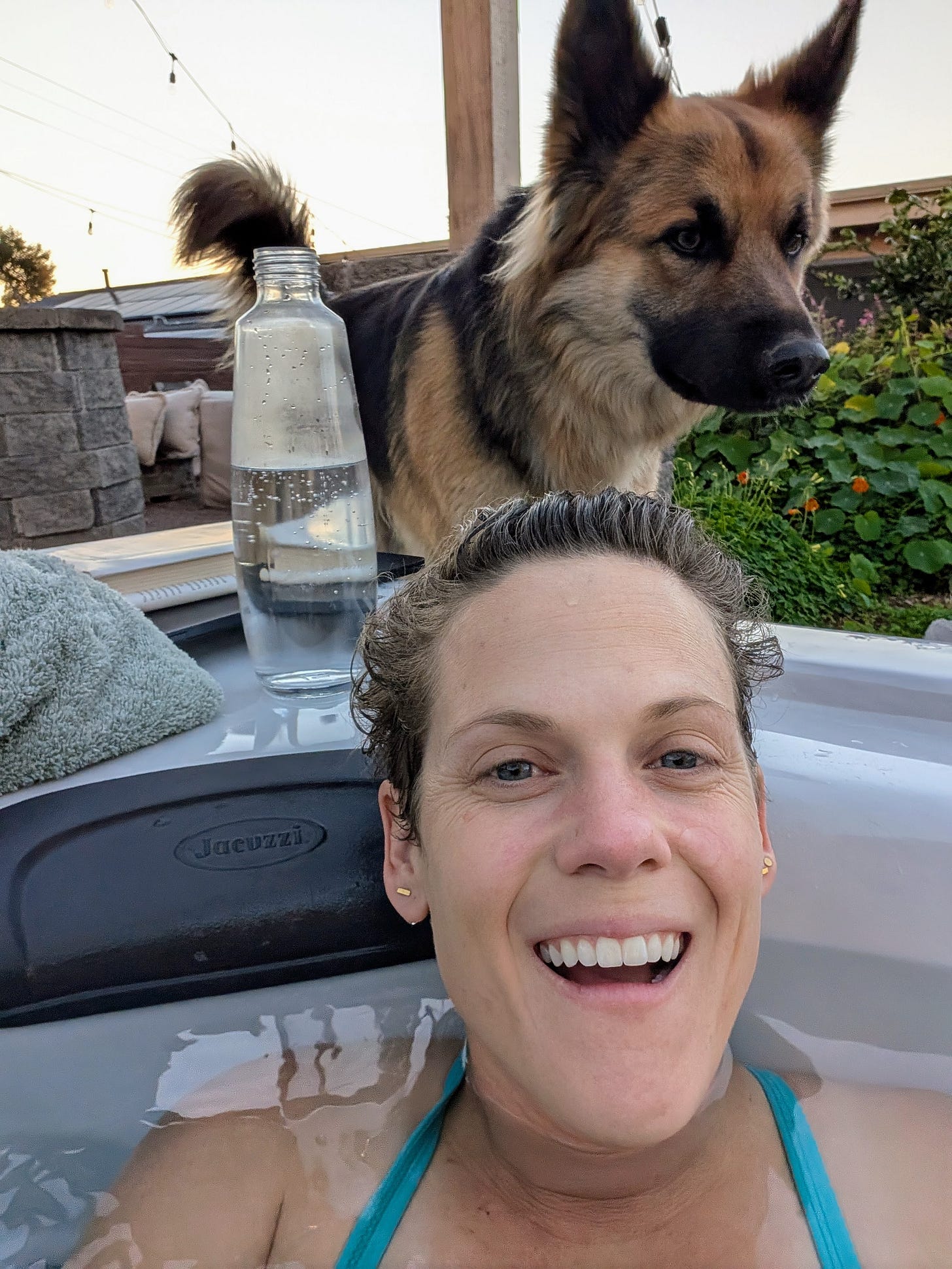 Caroline Davis smiling in a Jacuzzi hot tub with her German Shepherd Fletcher standing beside her outdoors Caroline Davis smiling in a Jacuzzi hot tub with her German Shepherd Fletcher standing beside her outdoors