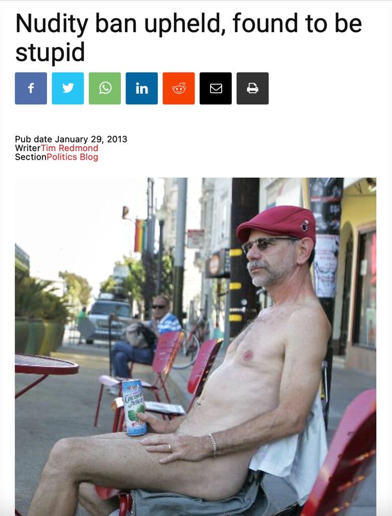 A 2013 article from the San Francisco Bay Guardian features a photo of Andy Tabbat nude in Jane Warner Plaza, holding a can of coconut juice. The headline above reads, “Nudity ban upheld, found to be stupid,” reflecting the publication’s critical stance on San Francisco’s new anti-nudity law.