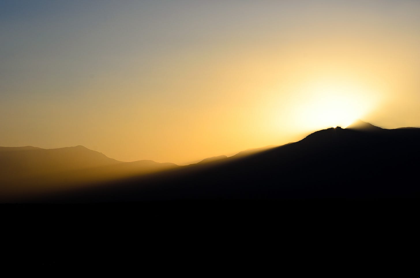 Light shining over a mountain.