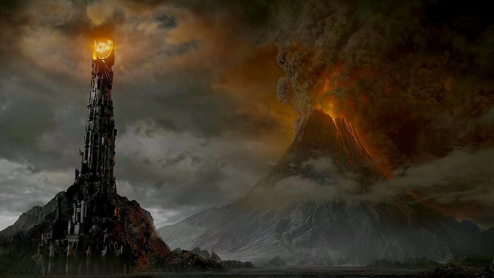 A still from The Return of the King depicting Barad-dûr, the Eye of Sauron, and an erupting Mount Doom