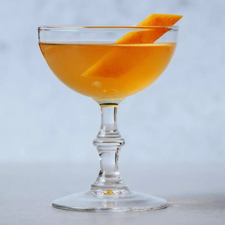 orange-hued Brotherhood cocktail in a coupe glass with an orange peel garnish orange-hued Brotherhood cocktail in a coupe glass with an orange peel garnish