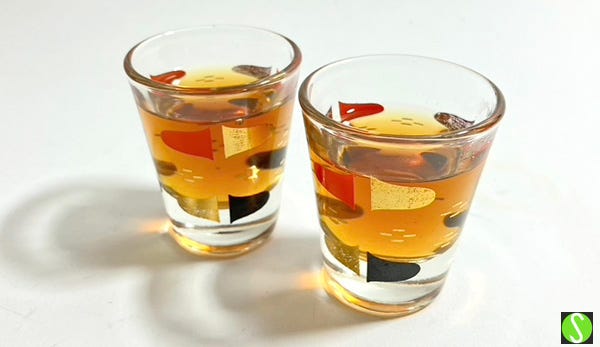 photo of two vintage shot glasses