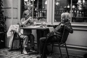 black and white photo of two women at an outdoor restaurant