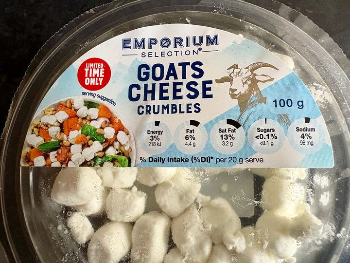 A packet of goats cheese and a salad 