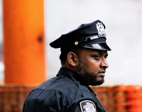 chief standing near body of water