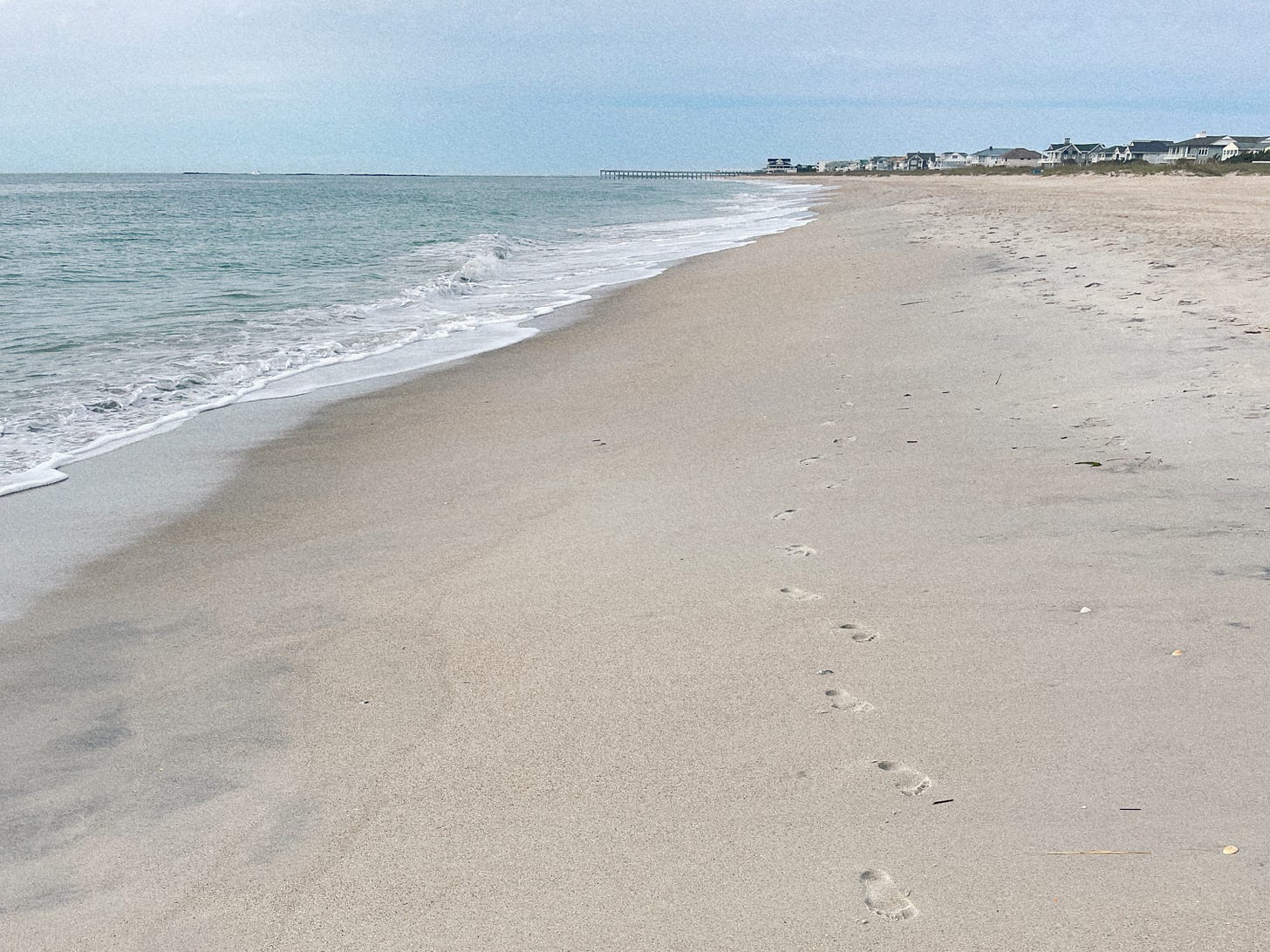 footprints in the sand on a beach