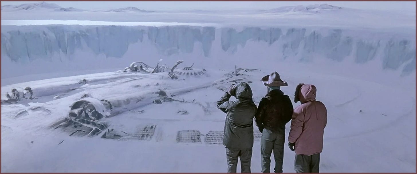 At the edge of a vast excavation site on the glacier. The rectangular void in the ice, achieved through a scale model and matte painting, dominates the left side of the frame. A wall of ice rises in the background.
