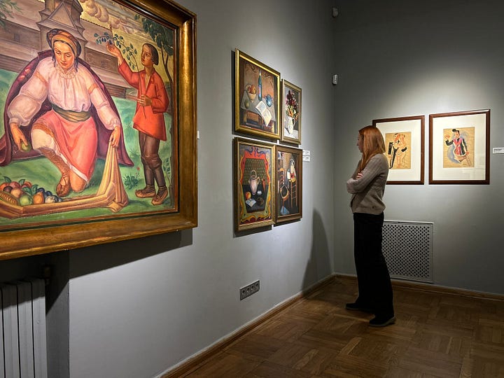 Visitors view artworks at a museum exhibition in Lviv.