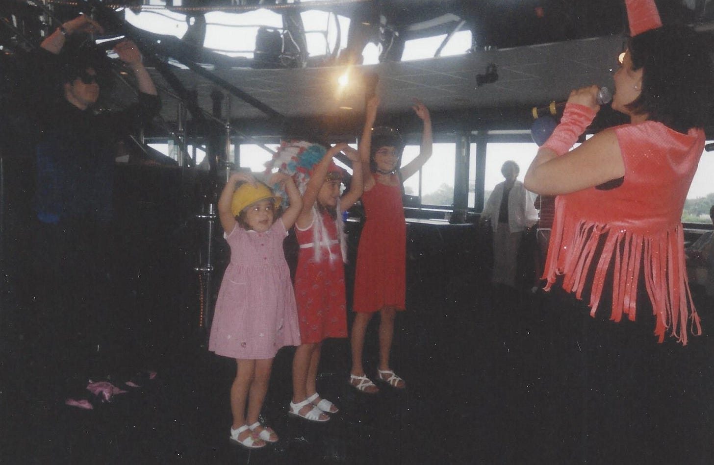 Three little girls on the dance floor doing the YMCA dance Three little girls on the dance floor doing the YMCA dance