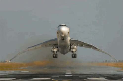 a plane is taking off from a runway with its wings spread