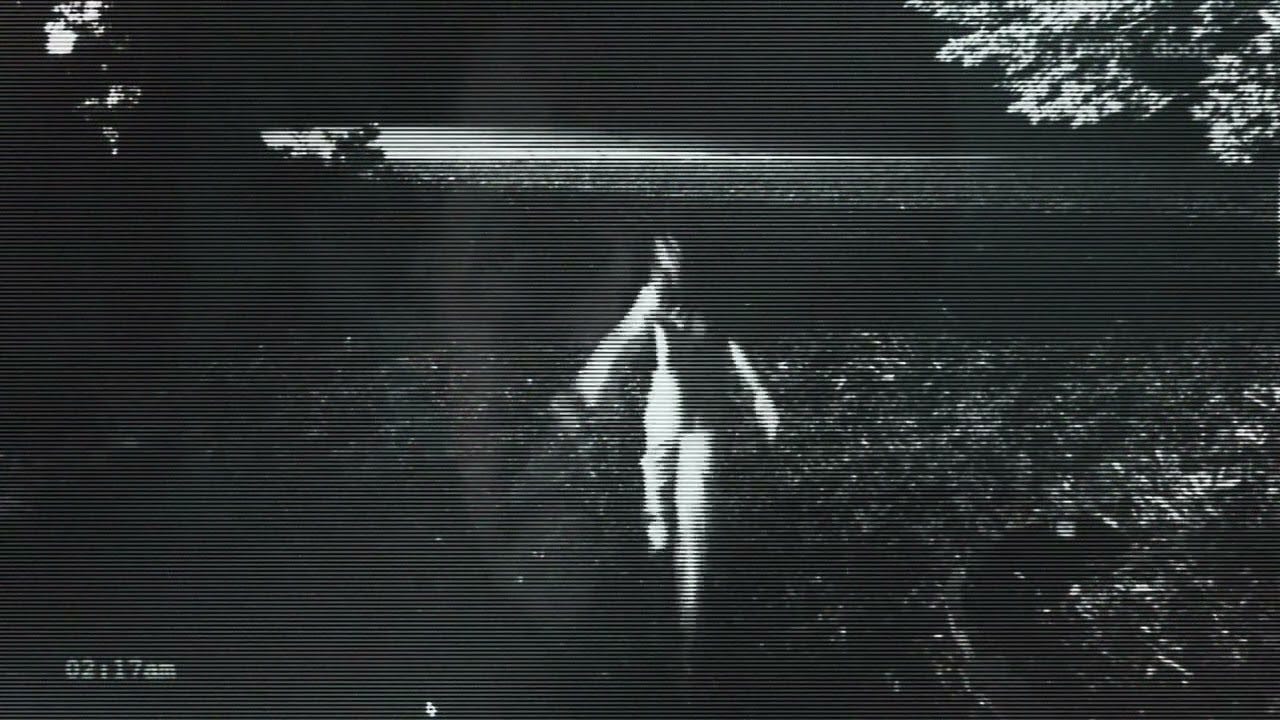 Blurry and grainy footage of a girl running with her arms outstretched behind her into the darkness. Blurry and grainy footage of a girl running with her arms outstretched behind her into the darkness.