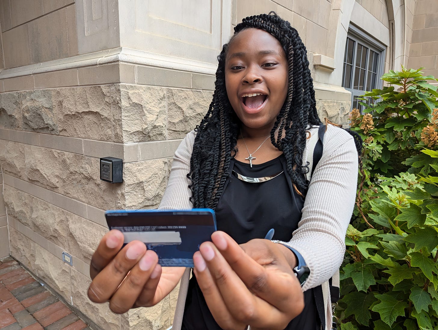 Deja considers - and rejects - a credit card. She works at a non-profit that helps kids get a college education without debt.