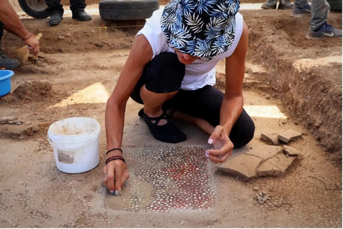 Archaeologists carefully cleaning the mosaic in the northern portico. Credit: Hellenic Ministry of Cultur Archaeologists carefully cleaning the mosaic in the northern portico. Credit: Hellenic Ministry of Cultur