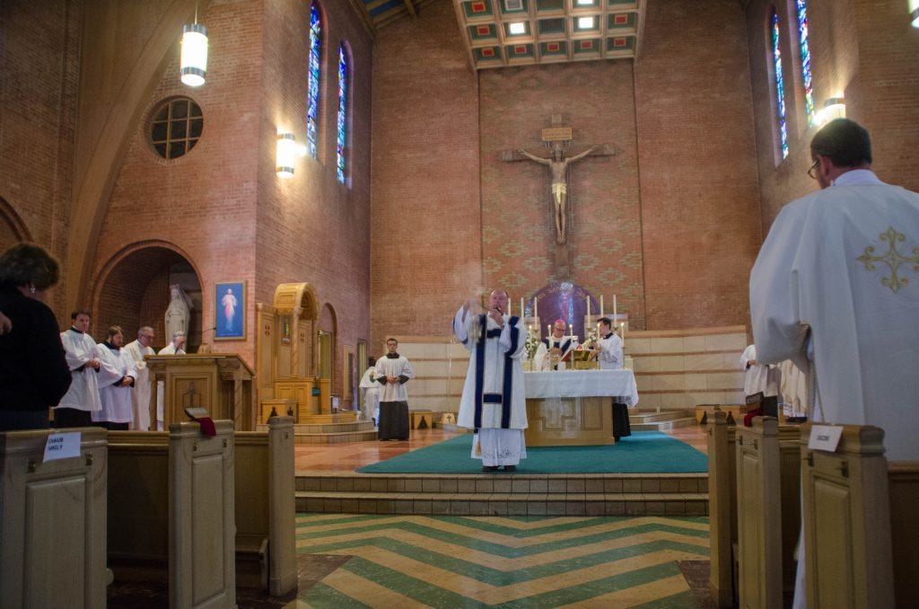 Cormack, now a deacon, blesses the congregation.
