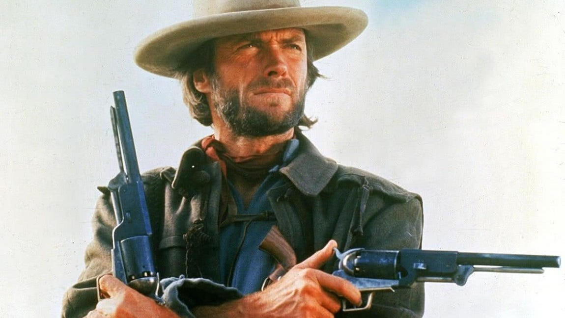 Clint Eastwood, a pistol in each hand, as Josey Wales.