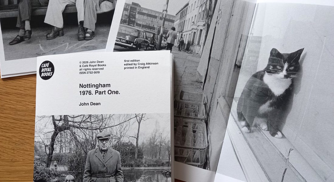 A collection of books with black and white photos on a wooden table