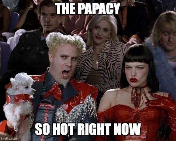 Mugatu from Zoolander holding a poodle, captioned "The papacy" and "So hot right now".