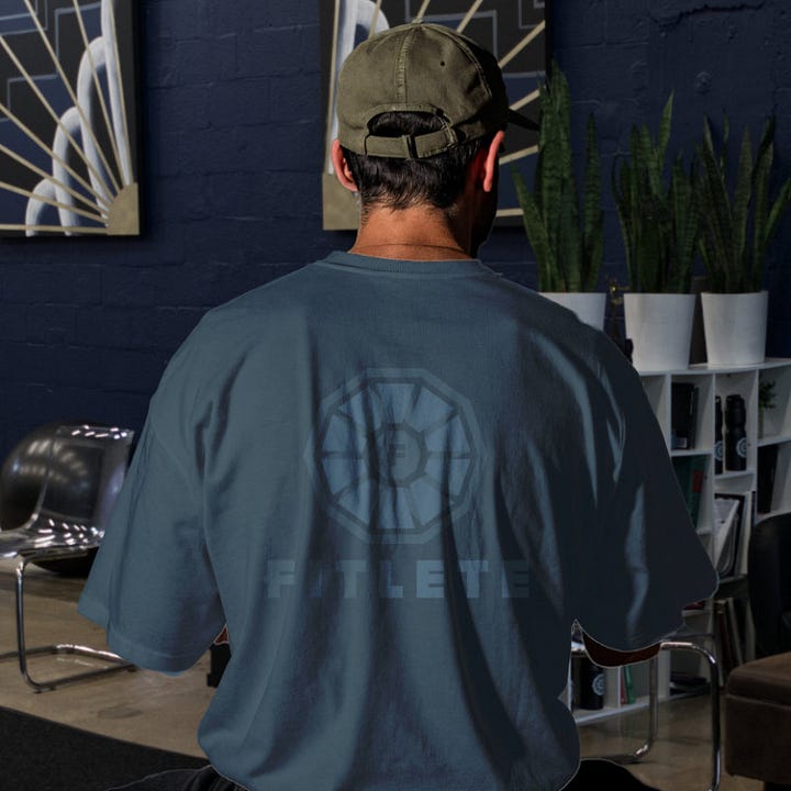 The toned fitlete logo sits on top of a shirt with its same color at a different shade or tone.